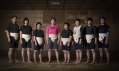 Eight of the current nine members of the Asahi University women sumo team pose for a group photo by the Dohyo