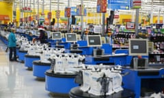 Employees work at the checkout counters of a Walmart store in Secaucus, New Jersey, November 11, 2015. REUTERS/Lucas Jackson