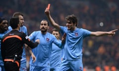 Trabzonspor’s Salih Dursun shows the red card to referee Deniz Ates Bitnel before receiving his own marching orders.