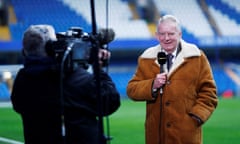 The late John Motson in 2016, presenting to camera at Stamford Bridge stadium, London.