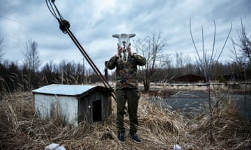 Tourist taking a souvenir photo. Chornobyl exclusion zone, 2015