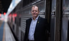 High Speed Rail Authority CEO Tim Parker stands on a platform beside a train at Central Station, Sydney