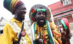 Rapso artist Brother Resistance (left) greets a parade participant during the annual Emancipation Day heritage festival on August 1, 2014 in Port of Spain, Trinidad.