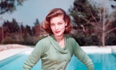 Lauren Bacall, US actress, weaing a green double-breasted cardigan and red trousers as he poses beside a swimming pool, circa 1950. (Photo by Silver Screen Collection/Getty Images)