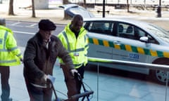 Older man is escorted by healthcare worker