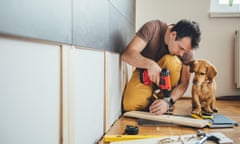 Man doing renovation work at home together with his small dog