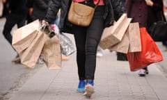 woman walking down street with shopping bags