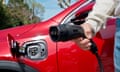 Hand close-up holding an electric plug-in car charger