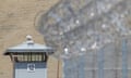 A guard tower and razor wire are seen at California State Prison