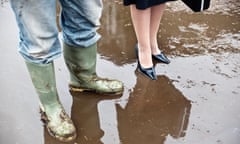 business woman with farmer in mud