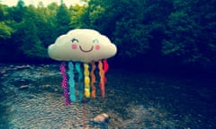 Cloud<br>helium balloon with face standing on river