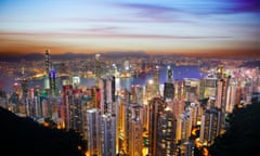 Hong Kong Victoria Harborbeautiful scenery of Hong Kong Victoria Harbor at dusk vista overlooking across the glittering concrete city of it iconic towering skyscrapers and high rise apartment blocks towards Kowloon view from Victoria Peak, China.