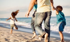 Family running on a beach