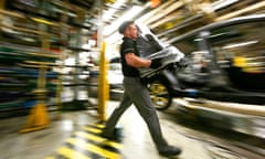 A Nissan worker prepares to fit a seat into a Qashqai SUV at the UK plant at Sunderland