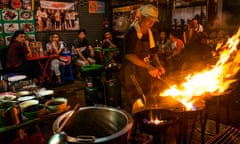 Tourists and locals await their food at a street restaraunt in Bangkok’s Chinatown.