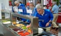 IOC president Thomas Bach tries food at the Olympic Village in Paris