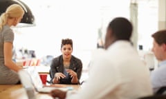 Creative business people reviewing proofs in office