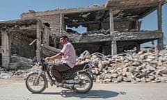 KOBANI, SYRIA - JUNE 19: A Kurdish man rides his motocycle in the destroyed Syrian town of Kobane, also known as Ain al-Arab, Syria. June 18, 2015. Kurdish fighters with the YPG took full control of Kobane and Tal Abyad, dealing a major blow to the Islamic State group's ability to wage war in Syria. Mopping up operations have started to make the town safe for the return of residents from Turkey, after more than a year of Islamic State militants holding control of the town. (Photo by Ahmet Sik/Getty Images)