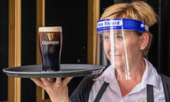 Barmaid in visor with pint of Guinness on a tray