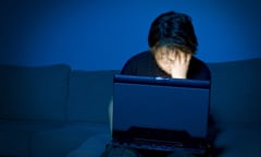 Boy using computer at night