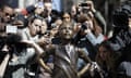 Statue of the Fearless Girl surrounded by photographers taking pictures