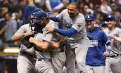 Clayton Kershaw is mobbed by teammates after closing out the Dodgers’ win over the Brewers
