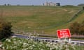 The government plans to build a two-mile road tunnel close to Stonehenge, despite strong opposition.