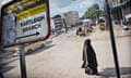 A veiled woman walks past a sign advertising Western Union on a street in Eastleigh, a district known locally as 'Little Mogadishu' due to its considerable Somali population. An influx of money has fuelled a construction boom in Eastleigh that has been variously attributed to laundered money originating from Somali piracy, fundraising activities of al-Shabab and other Islamist groups or simply that Eastleigh has become the focal point for investment for Somalis worldwide.