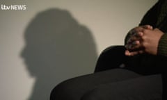 Picture of a Black woman's folded hands and the shadow of her face against a wall with the words "ITV News" in the corner