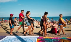 Sunseekers on the beach at La Barceloneta.