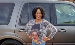 A woman posing in front of a car with her hands on her hips