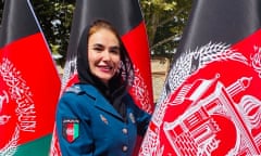 Afghan policewoman Gulafroz Ebtekar pictured in uniform among Afghanistan flags