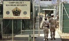 FILE - In this June 27, 2006 file photo, reviewed by a U.S. Department of Defense official, U.S. military guards walk within Camp Delta military-run prison, at the Guantanamo Bay U.S. Naval Base, Cuba. Fears that Donald Trump will make good on his pledge to bring more prisoners to the U.S. base in Cuba have human rights groups making a final push for President Obama to close the detention center before he leaves office. But the odds are against that with 60 prisoners left, only a third currently cleared for release. (AP Photo/Brennan Linsley, File)