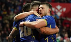 Warrington’s Connor Wrench (20) celebrates with teammates after scoring their fourth try against Hull KR.