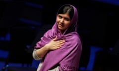 Malala Yousafzai in a scarf, hand on heart, speaking at the WOW festival in 2014