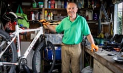 Paul Wilcox, who repairs donated bikes and resells them on ebay for charity. Photographed in his garden, where he works on the bikes. 13 June 2022. For Guardian Angels