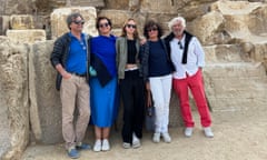 Five people in front of large stones