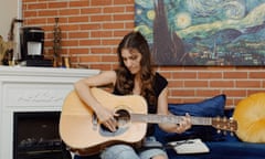 woman playing guitar in a living room