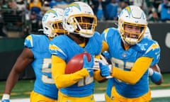 The Los Angeles Chargers’ Derius Davis, left, celebrates his punt return touchdown