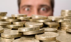 Man looking at stack off pound coins