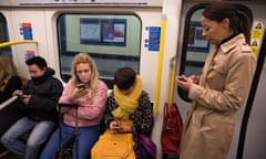 People Looking At Their Mobile Phones<br>Commuters on the London Underground, check their mobile phone on 26th February 2017 in London, United Kingdom. From the series Our Small World, an observation of our mobile phone obsessions (photo by Sam Mellish / In Pictures via Getty Images Images)