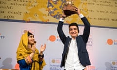 Mohamad Al Jounde holds up the International Children’s Peace Prize, given to him by Malala Yousafzai (left).
