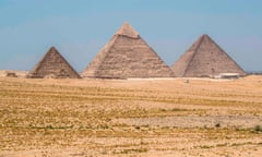 EGYPT-TOURISM-HEALTH-VIRUS<br>This picture taken on July 1, 2020 shows a general view of (R to L) the Great Great Pyramid of Khufu (Cheops), the Pyramid of Khafre (Chephren), and the Pyramid of Menkaure (Menkheres) at the Giza Pyramids necropolis on the southwestern outskirts of the Egyptian capital Cairo, as the archaeological site reopens while the country eases restrictions put in place due to the COVID-19 coronavirus pandemic. - A spree of openings in Egypt comes after the country officially ended a three-month nighttime curfew a few days earlier. Cafes and shops have re-opened but public beaches and parks remain closed as part of measures to curb the spread of the novel coronavirus. Egypt has recorded more than 65,000 COVID-19 cases including over 2,700 deaths. (Photo by Khaled DESOUKI / AFP) (Photo by KHALED DESOUKI/AFP via Getty Images)