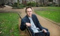 Steven Cummins on a park bench in front of the London School of Hygiene and Tropical Medicine