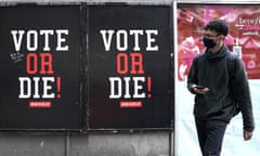 A man walks by a advertisement by Sean ‘Diddy’ Combs’ VOTE or DIE! campaign.