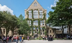 University of Manchester students stand outside the Old Quad building with their family and friends after a graduation ceremony