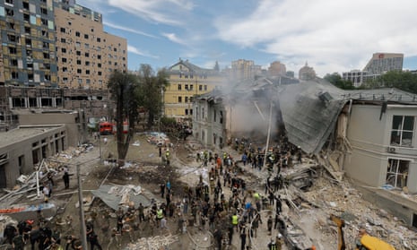 Ukrainians working at the site of a rocket strike on the 'Okhmadyt' children's hospital in Kyiv, Ukraine.