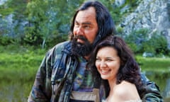 Father hugs daughter on a background of wildlife.<br>Brutal man hugs a pretty mature woman who is smiling. This is a married couple, father and daughter, or brother and sister. Family of farmers posing for a photographer in nature.