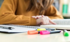 Young unrecognisable female college student in class, reading textbook. Focused student in classroom. Authentic Education concept.<br>M8R47T Young unrecognisable female college student in class, reading textbook. Focused student in classroom. Authentic Education concept.