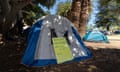 A tent in a park with a sign citing the human rights charter